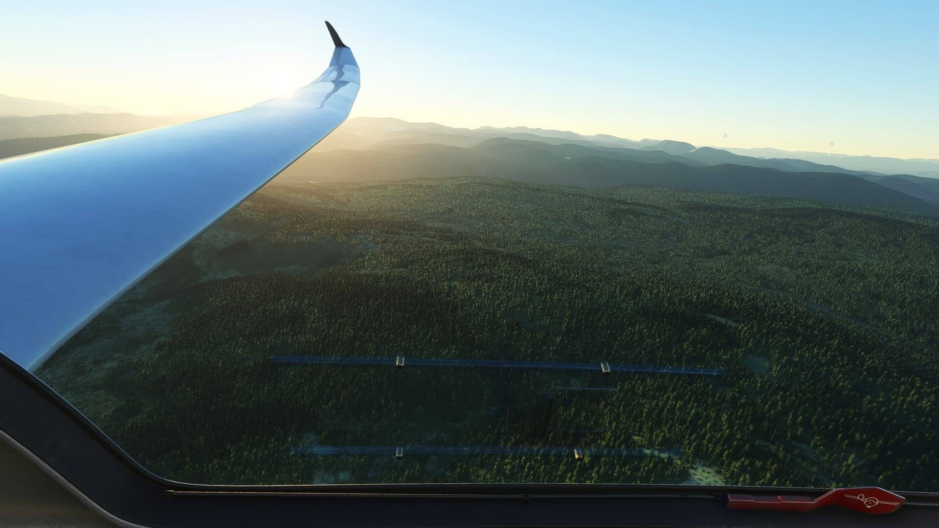 The view from the cockpit of a glider looking at the left wing