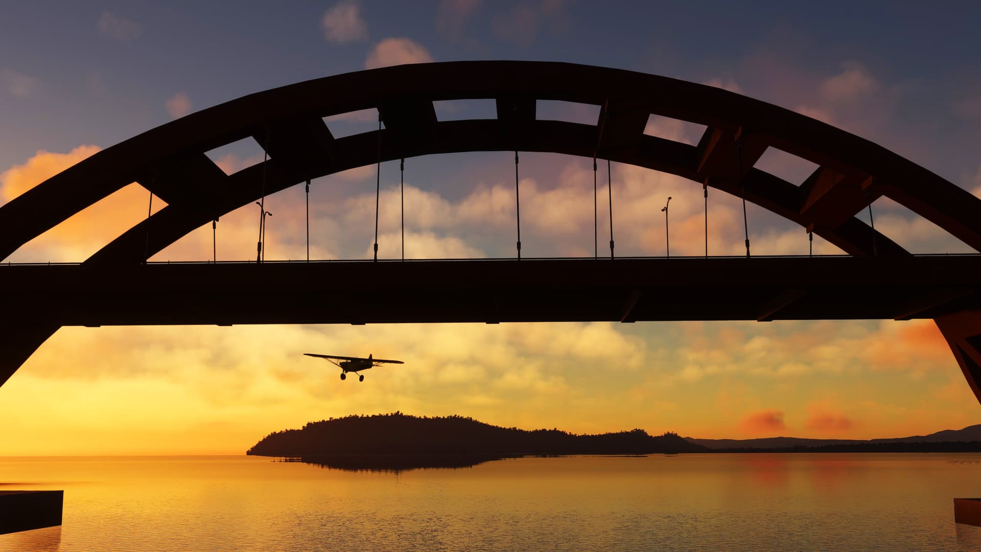 The silhouette of a propeller aircraft passing below a bridge during golden hour