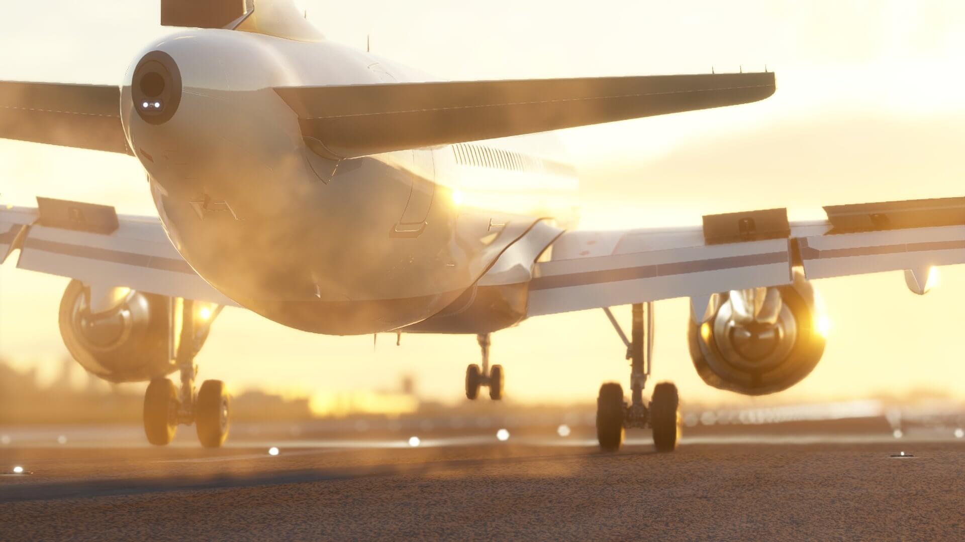 An Airbus airliner touches down with spoilers deploying on the wings, and sun shining off of the fuselage and engine cowling