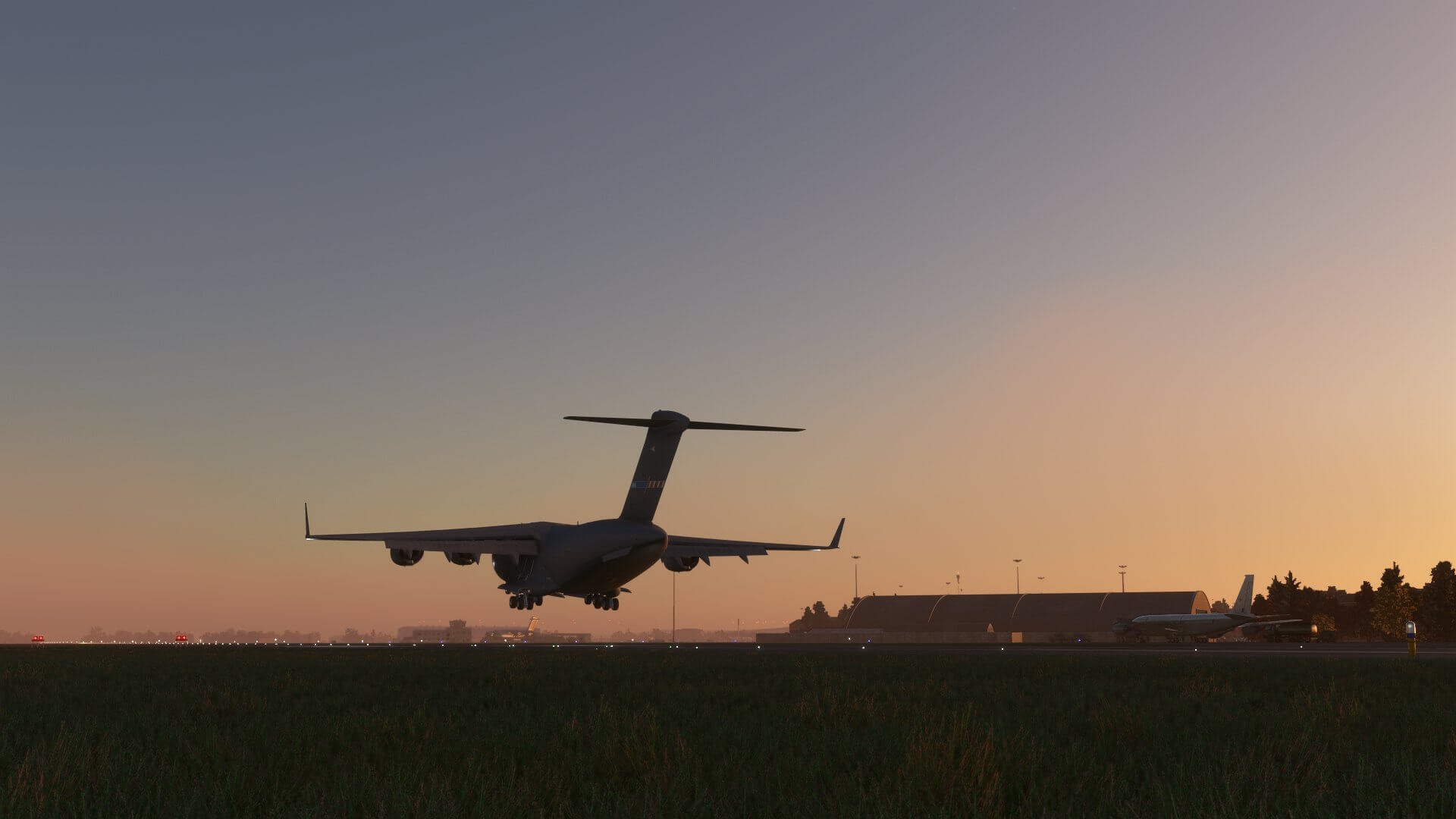 A C-17 Globemaster flares for landing at a military airport