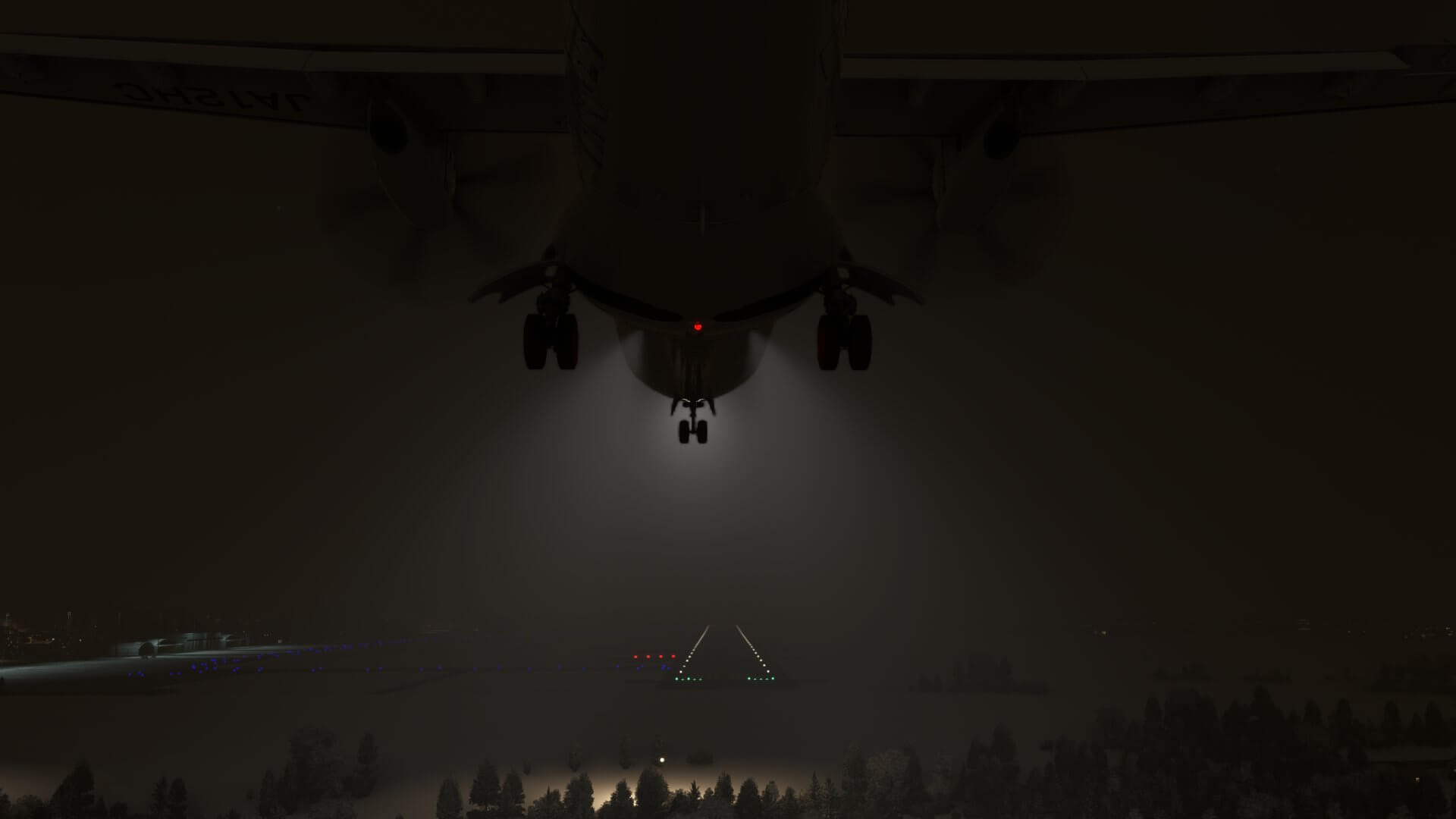 An ATR comes into land at a snowy airport at night