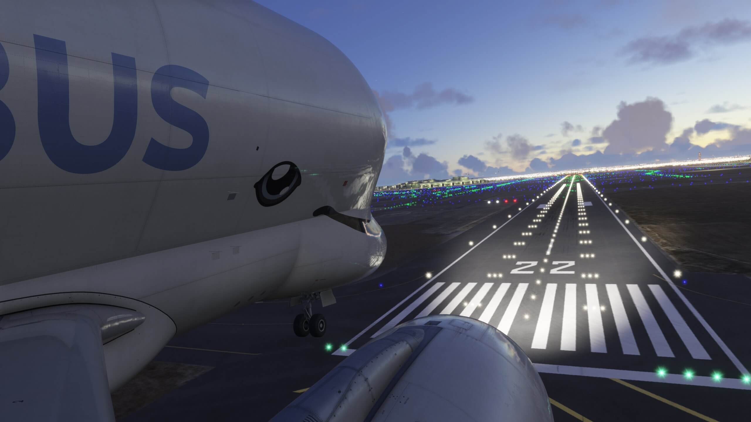 An Airbus Beluga XL crosses over the runway tiles whilst on short final to land at an international airport