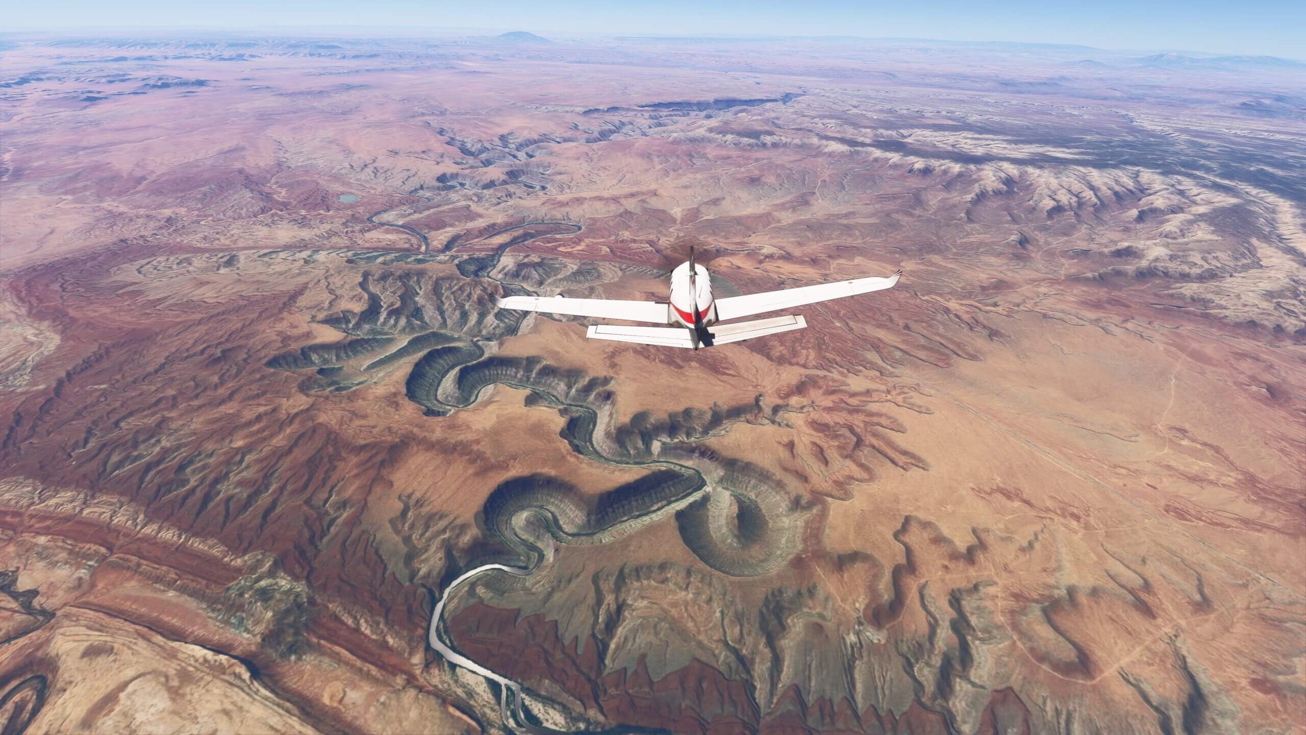 A TBM930 cruises above a desert