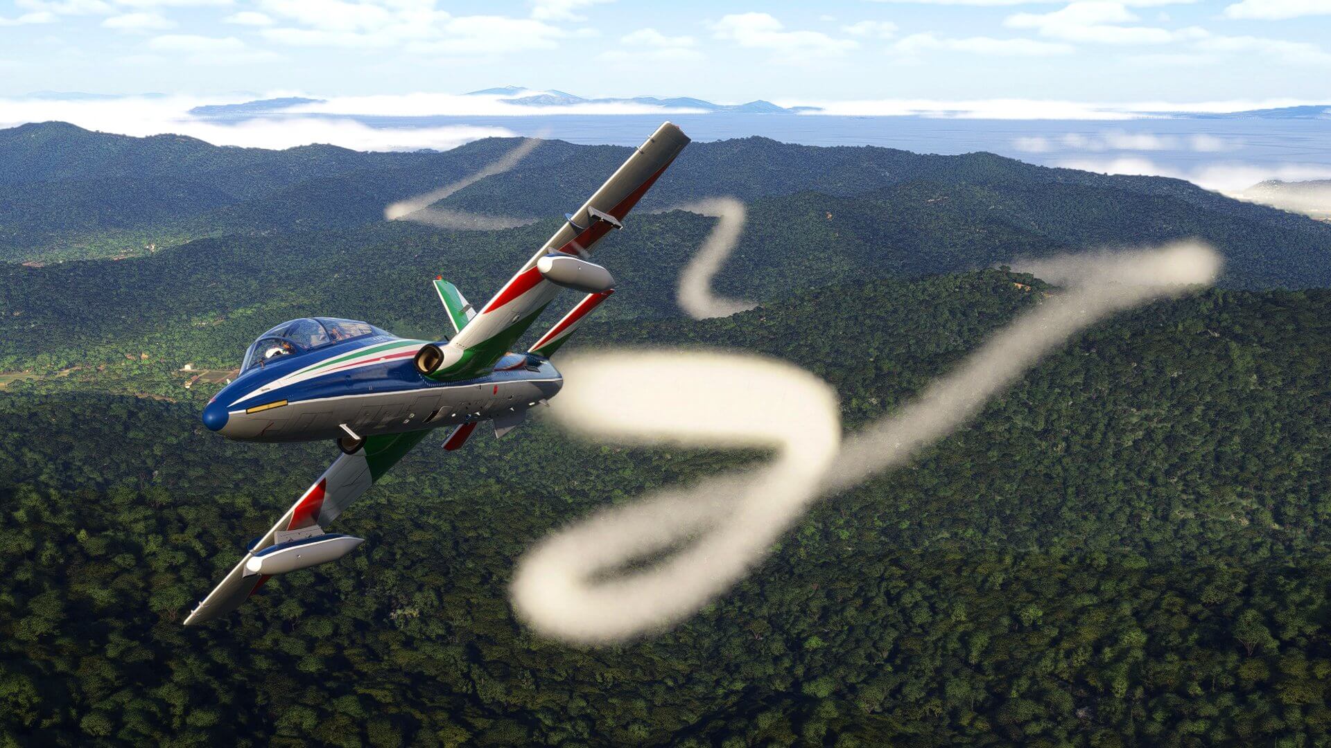 A blue aerobatic aircraft plumes white smoke over a dense forest