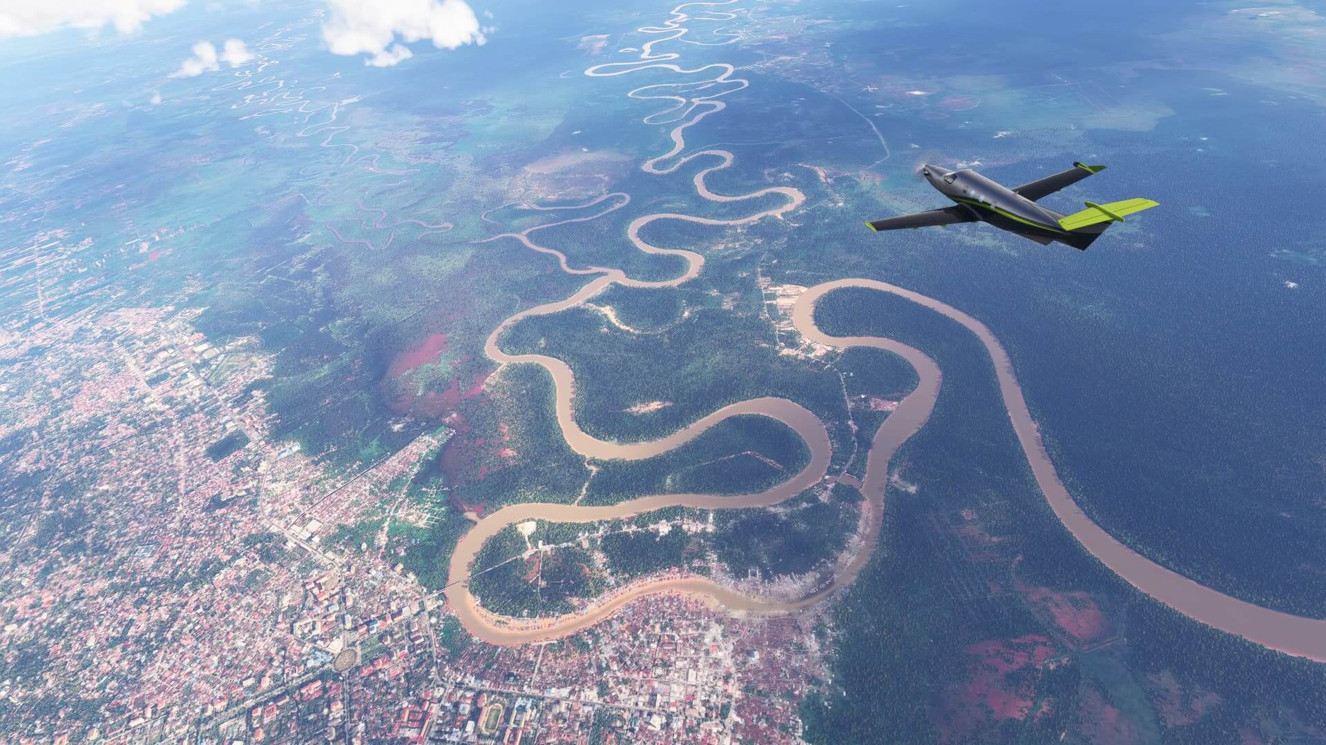 A PC-12 cruises high over a winding river