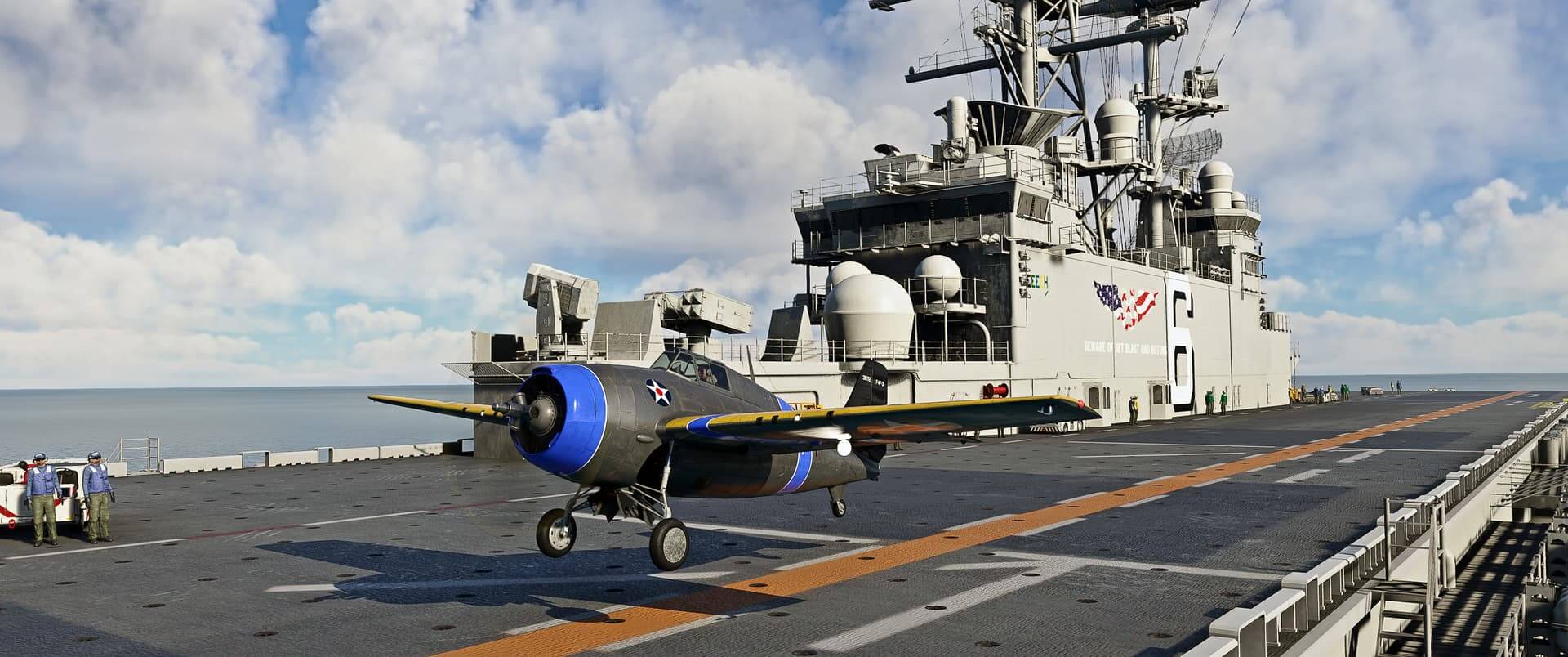 A military propeller aircraft lands on the deck of an aircraft carrier