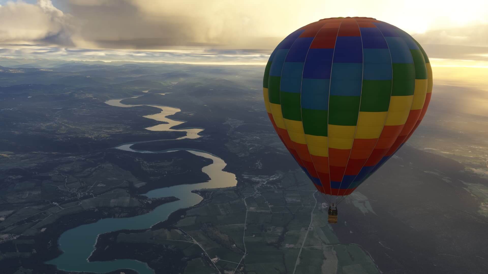 A hot air balloon taking in the view over a winding river