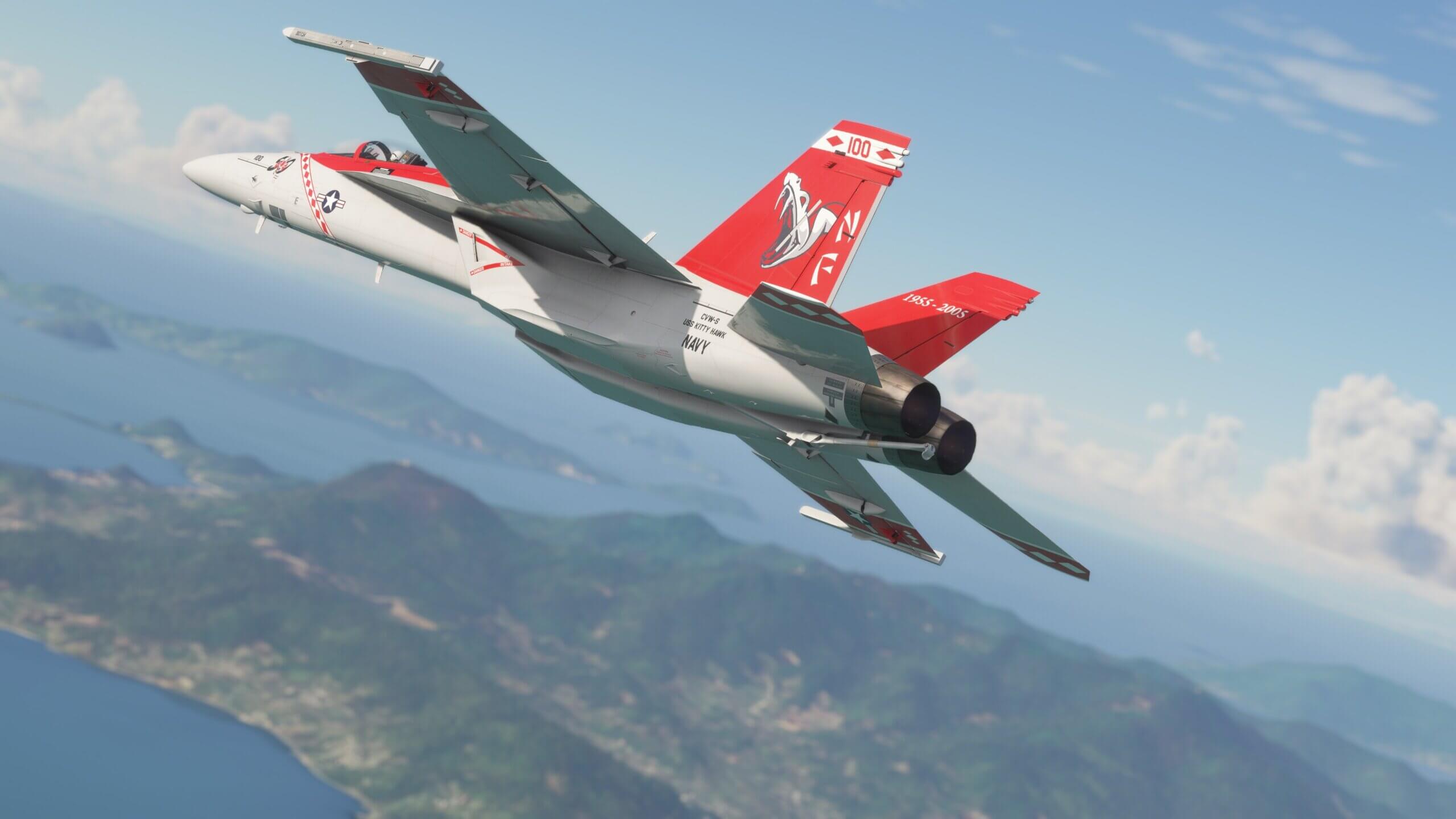 An F-18 Hornet cruises with Red Snake paint scheme