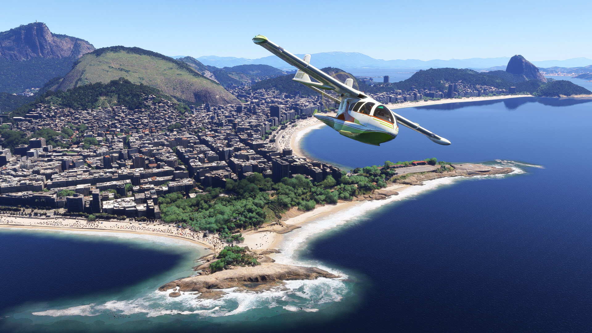 A white propeller aircraft passes over a rocky beach with the city of Rio De Janeiro in the background