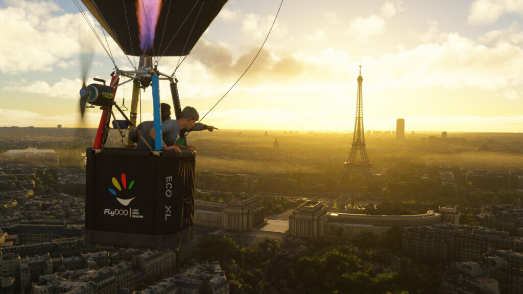 A hot air balloon tours above Paris, with the Eiffel Tower in the distance.