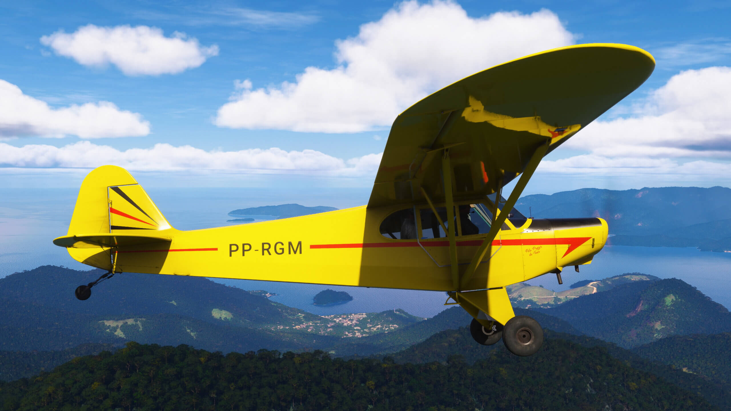 A yellow CAP4 Paulistinha flies above a river.