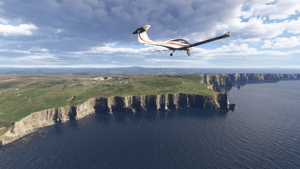 An airplane flies above a cliff during the daytime.