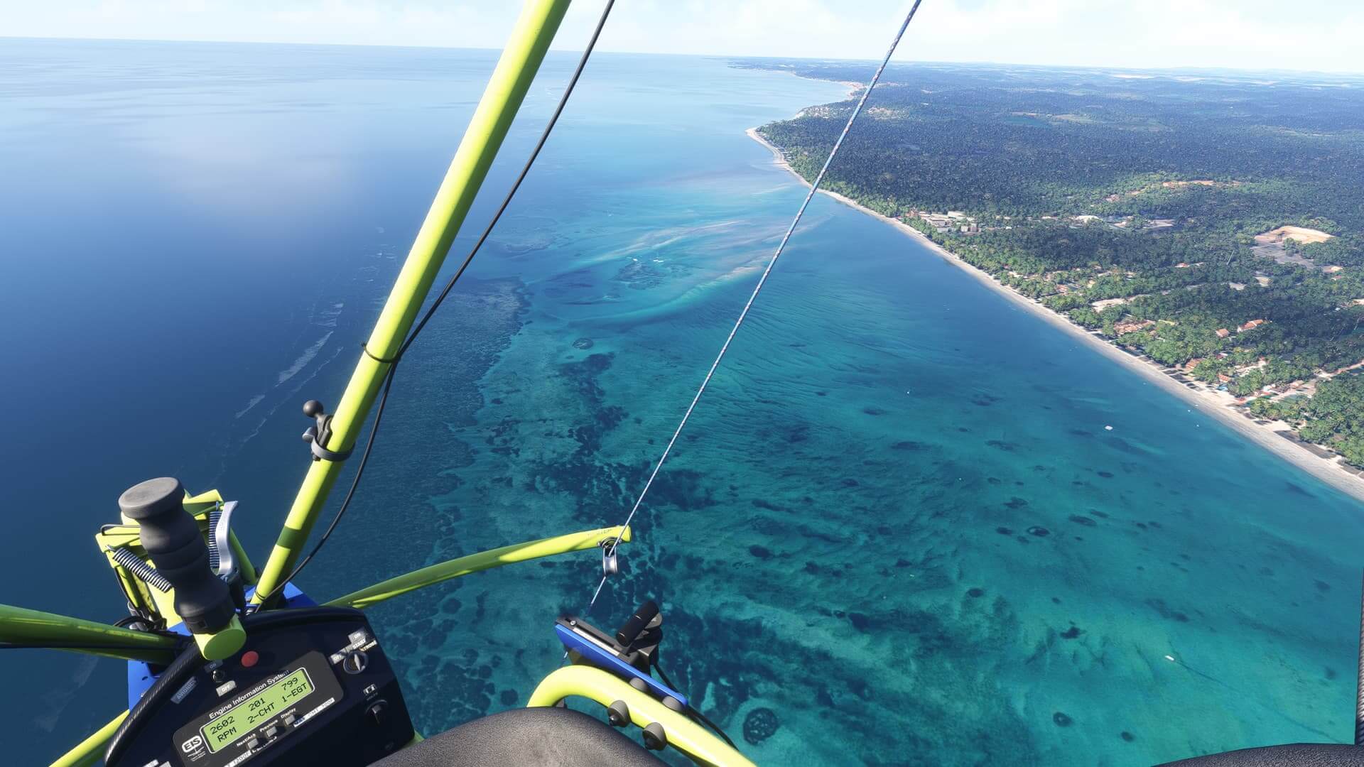 A view from an aircraft looking down at the shoreline of a beach