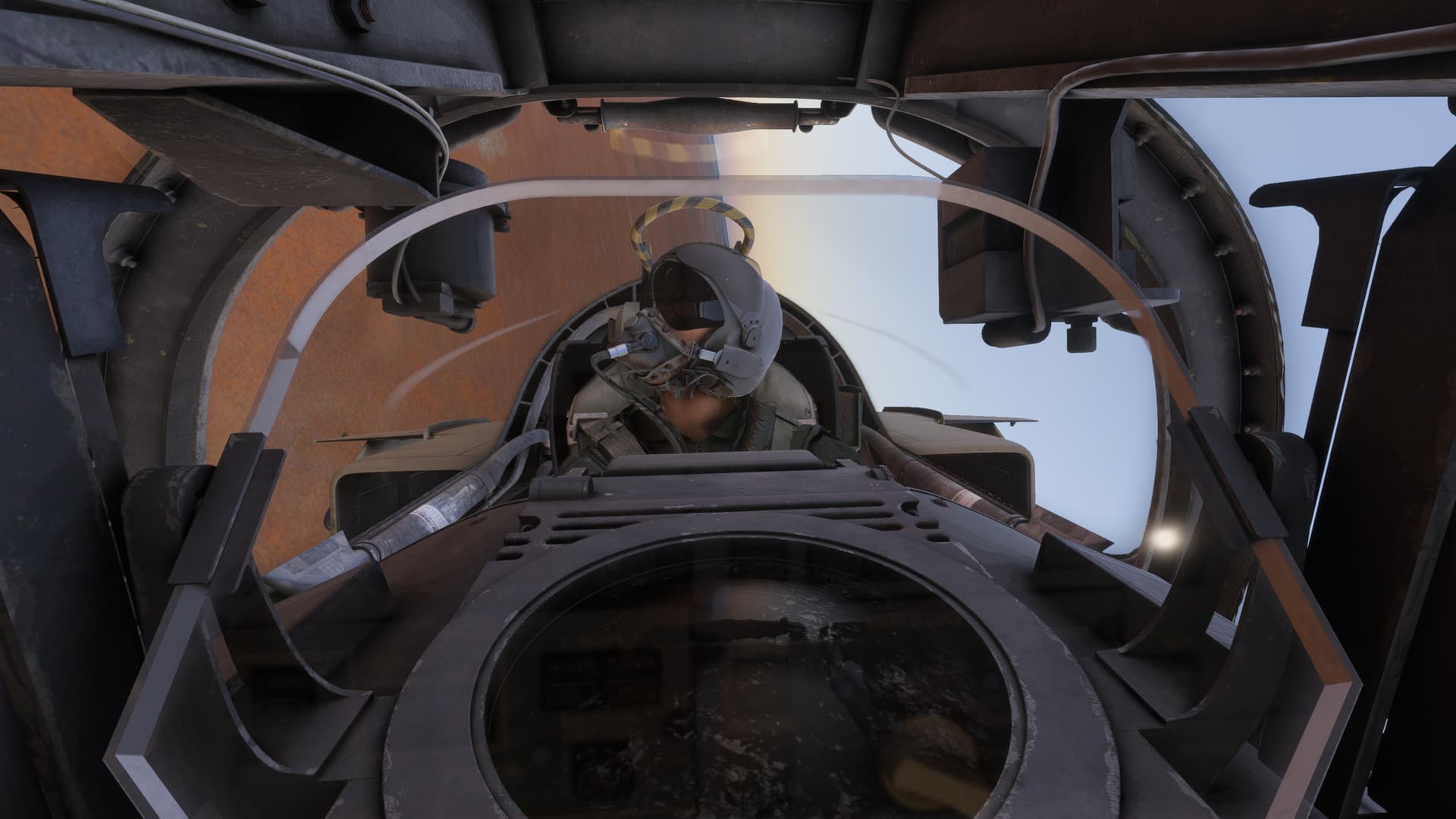 A fighter pilot looks out the window of his cockpit whilst in a steep turn