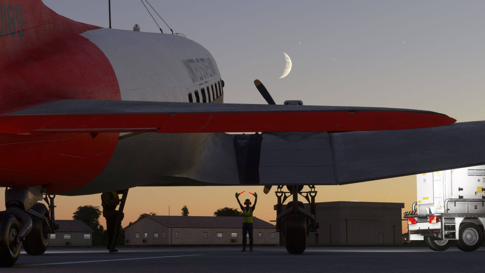 A DC-3 parking on a ramp with ground crew in place