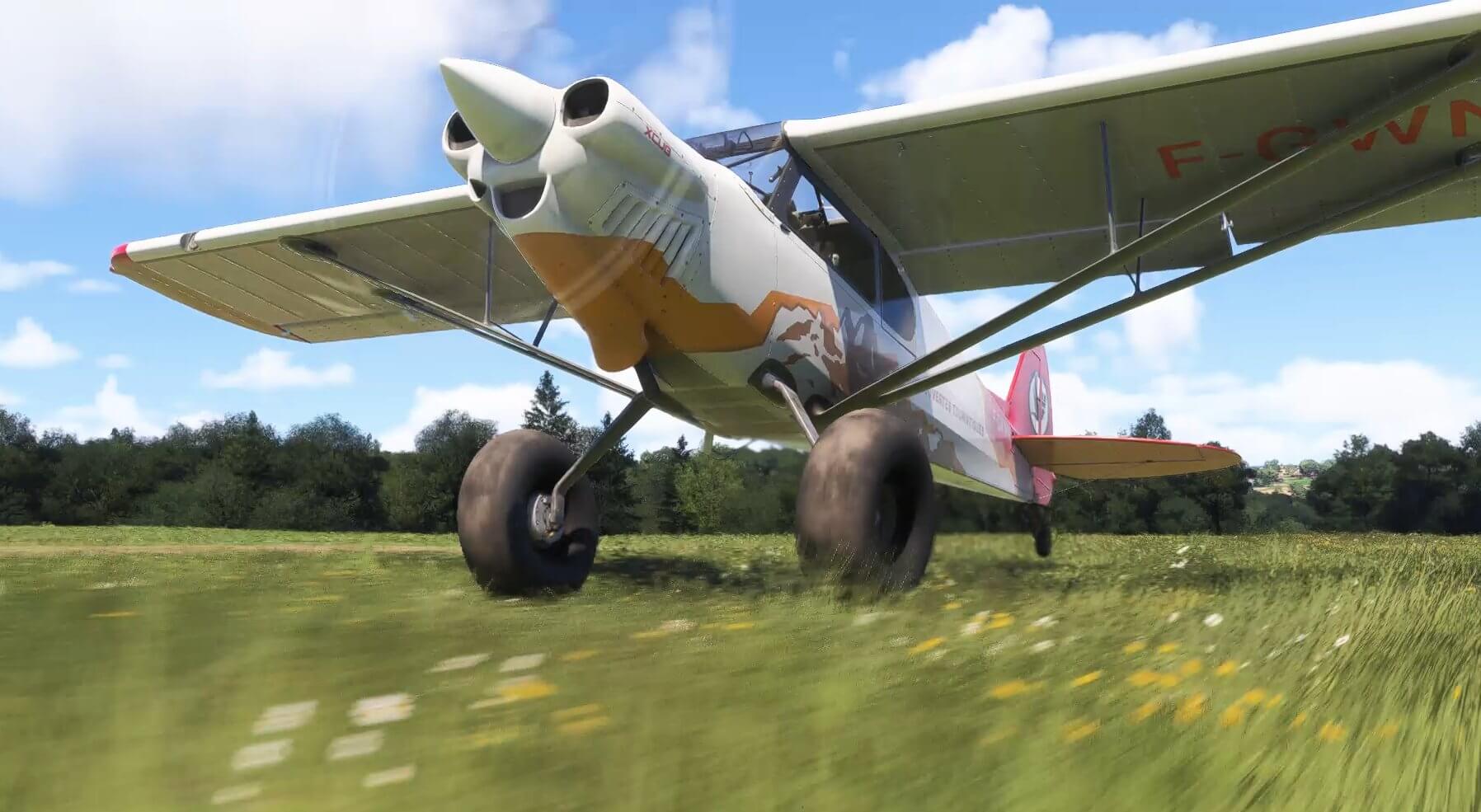 An X-Cub gains momentum on takeoff roll from a grass runway