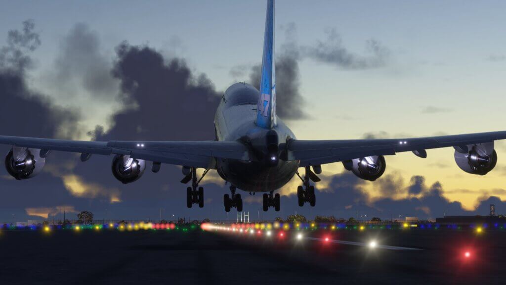 A Boeing 747 rotating from a runway at night