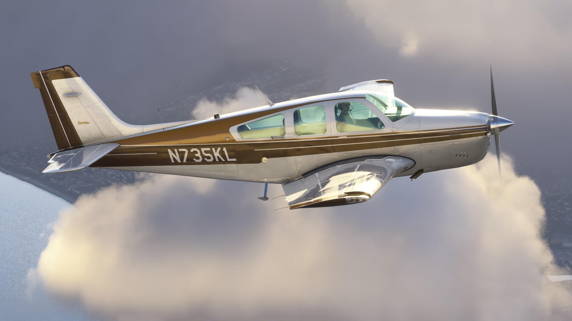 A F33A flies in front of clouds.