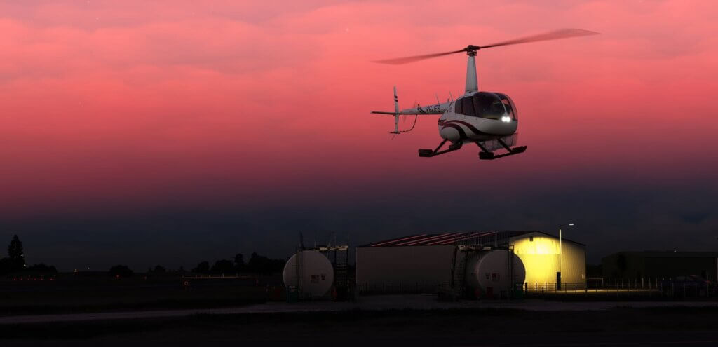 A Robinson R66 hovering during a flight after sunset