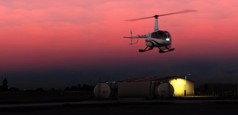 A Robinson R66 hovering during a flight after sunset