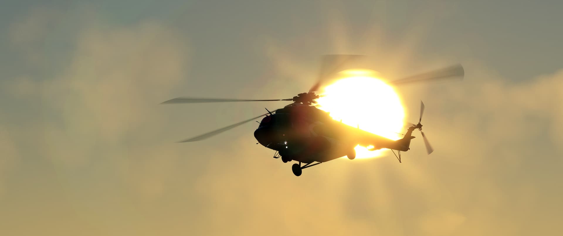 A helicopter silhouetted by the sun directly above