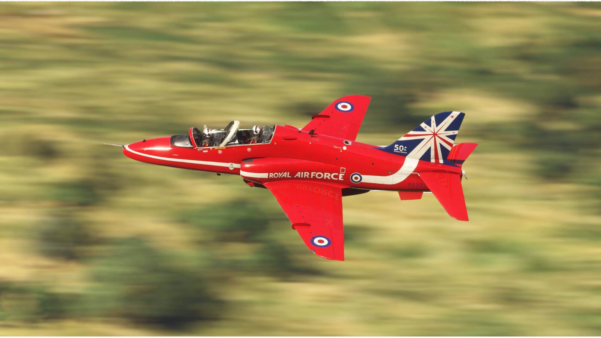 A Royal Air Force Red Arrows Hawk flying at fast speed