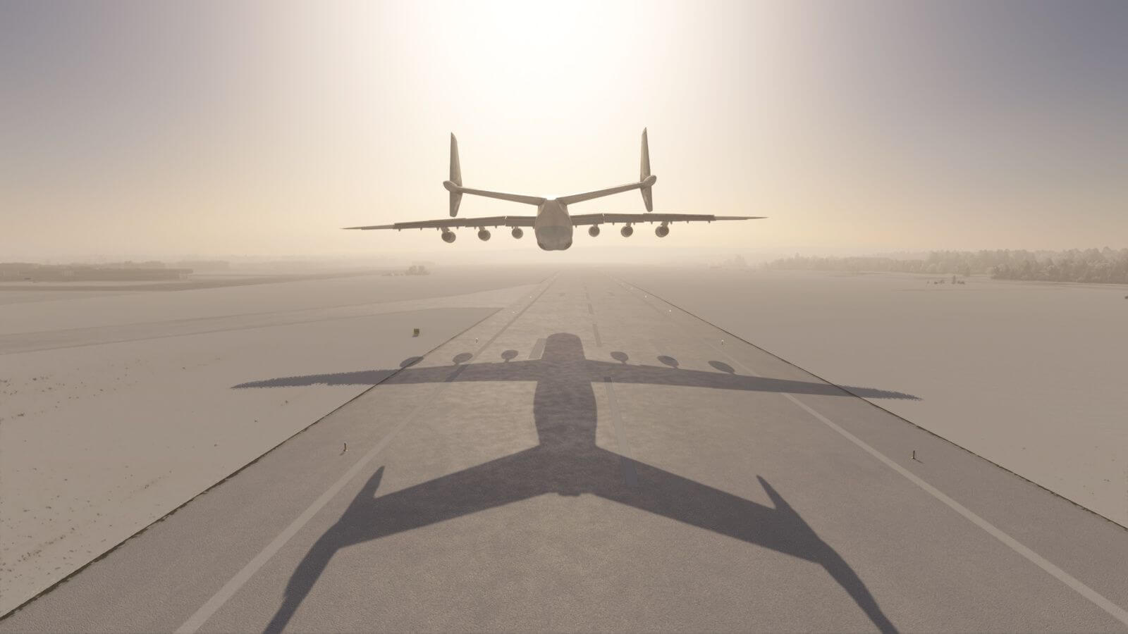 An Antonov AN-225 flies love over a snowy runway with shadow casting on the tarmac below