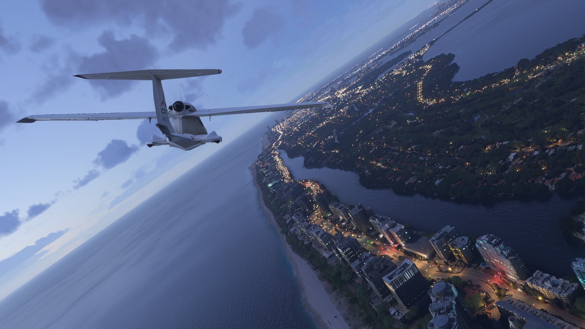 An Icon A5 banks right whilst flying along a beach coastline