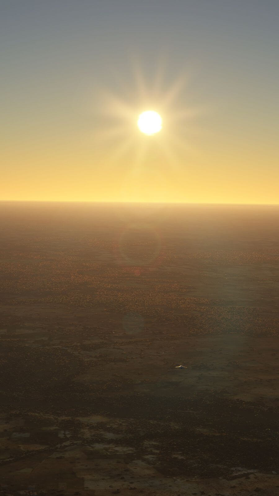 The sun shines bright above a desert. An aircraft is nearly a speck as it flies over it.