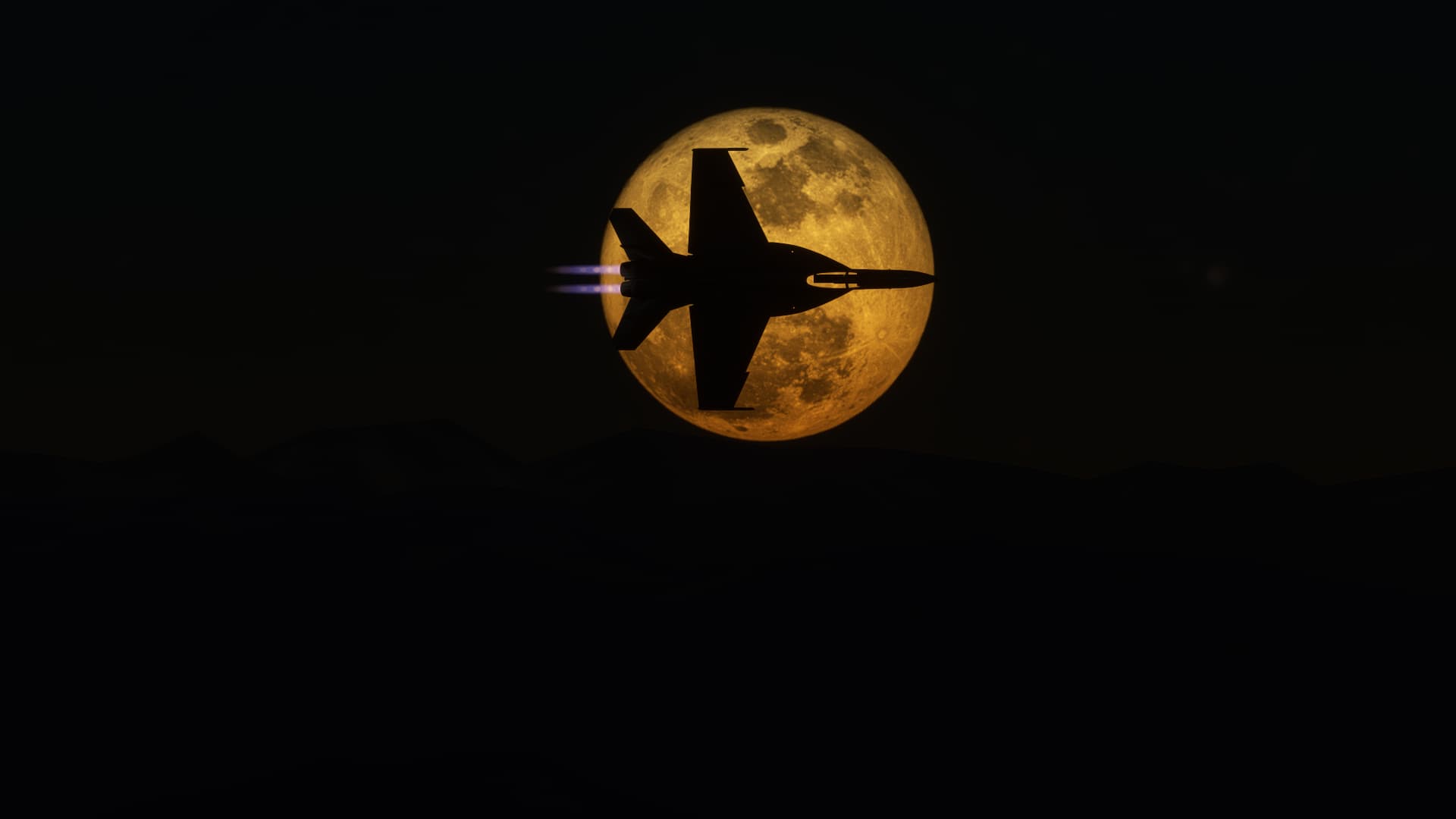 An F/A-18 Hornet with afterburner engaged silhouetted against the moon behind