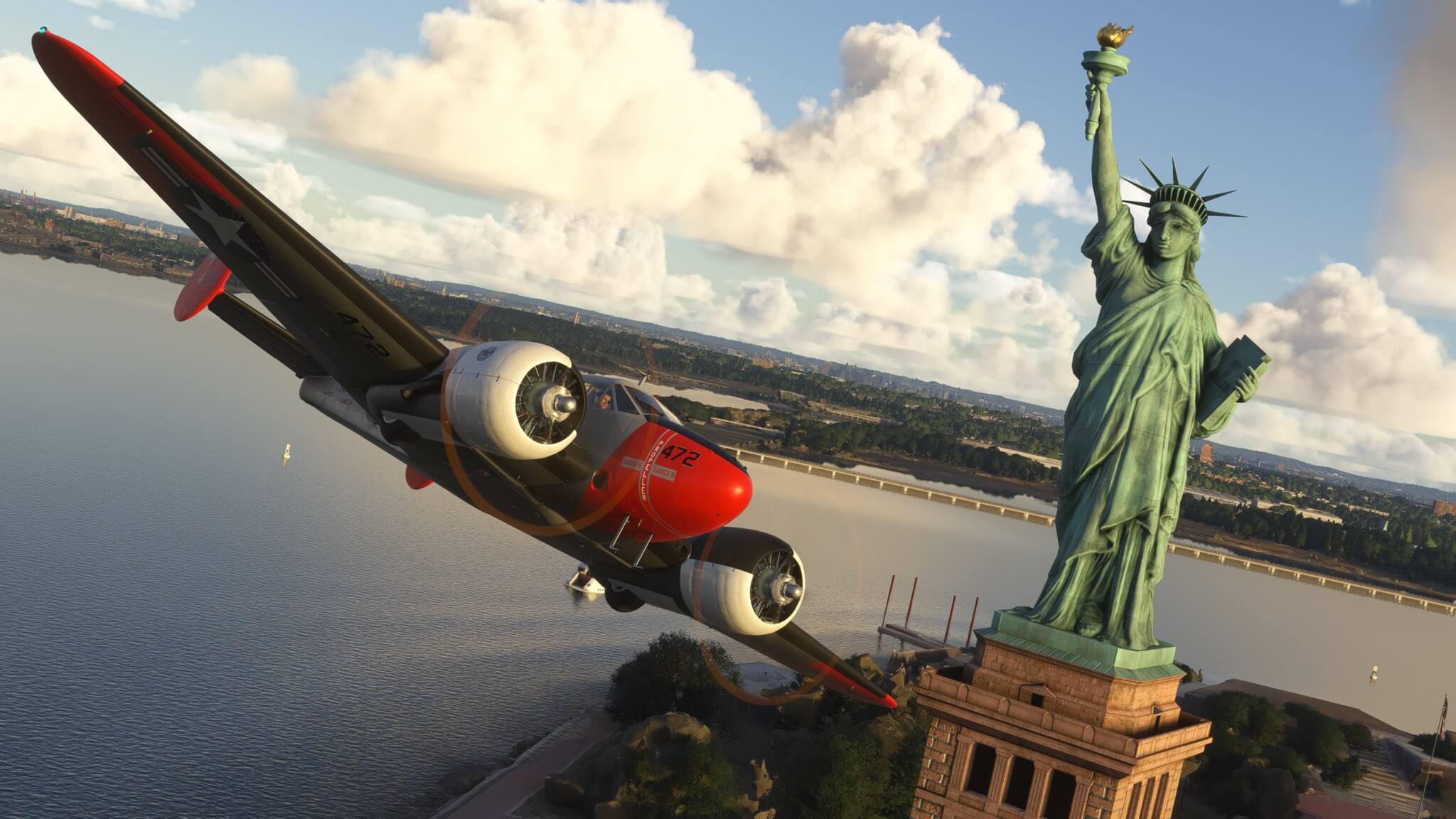 A dual propeller aircraft does a fly past near the Statue of Liberty, New York