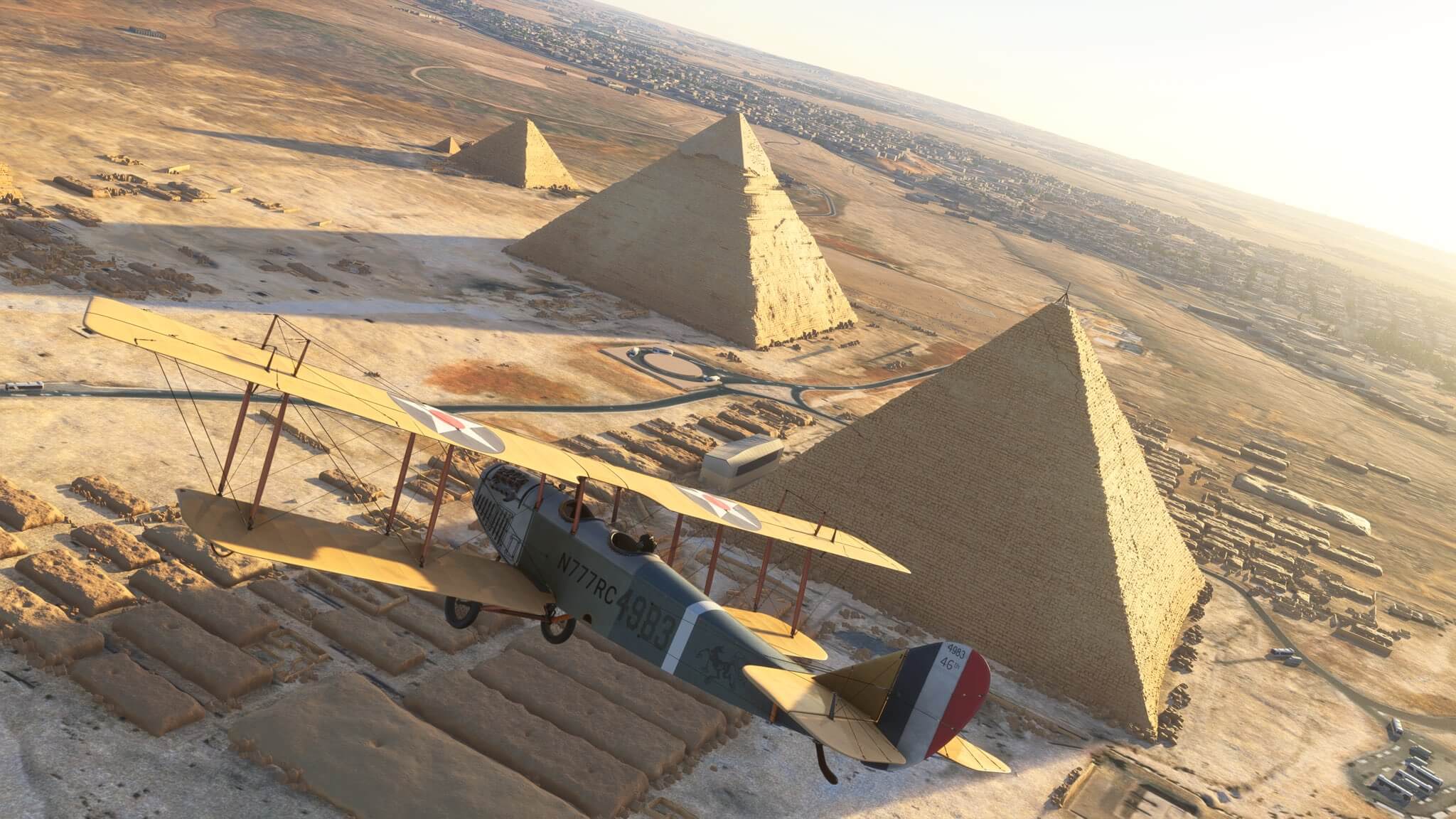 A dual-wing propeller aircraft flies close to the Pyramids of Giza, Egypt