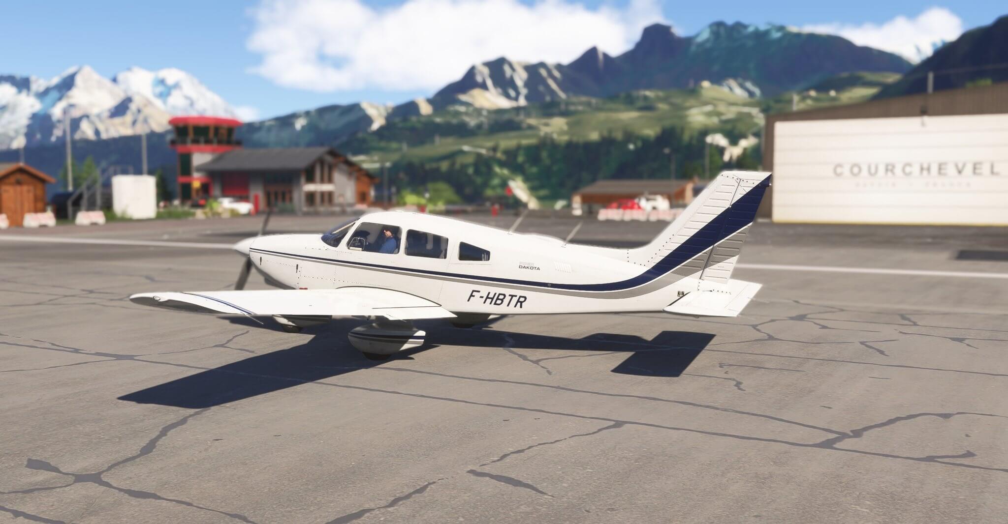 A Piper PA-28-236 Dakota sitting idle on the apron at Courchevel airport