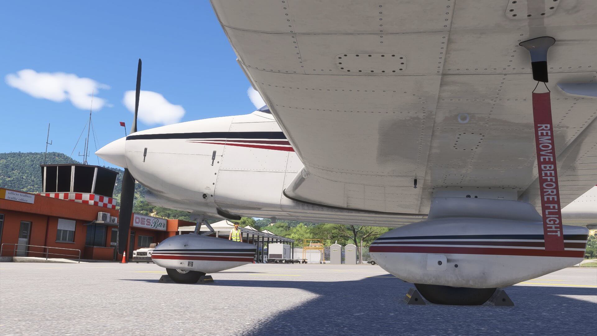 A view under the wing of the Piper PA-28-236 Dakota sitting idle on an aircraft ramp