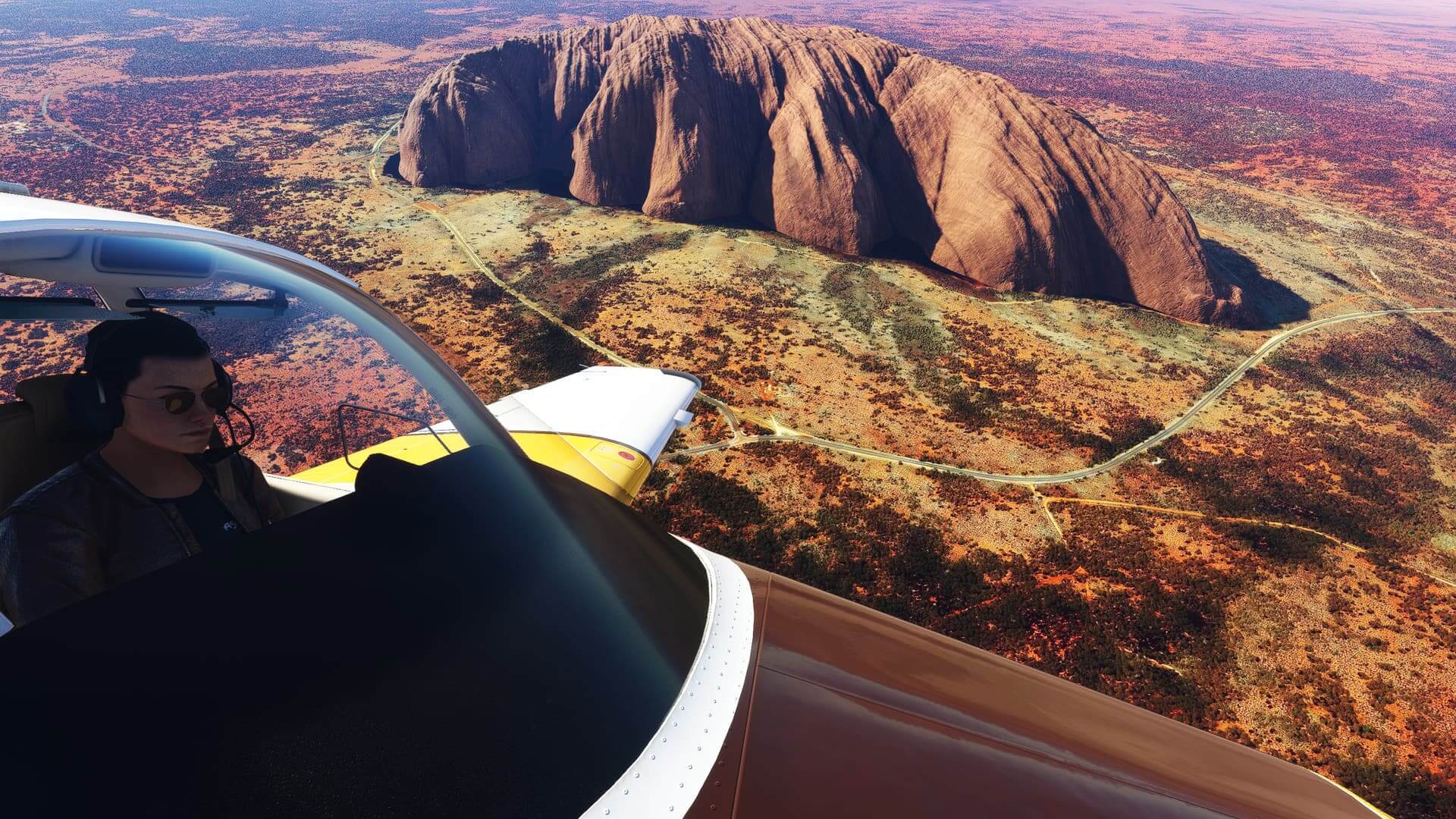 An aircraft banks left to get a better view of Ayers Rock, Australia