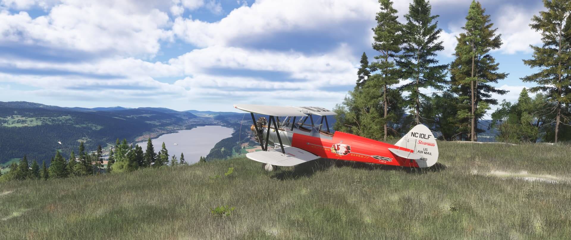 A dual wing propeller aircraft looking into a valley whilst parked on a hill