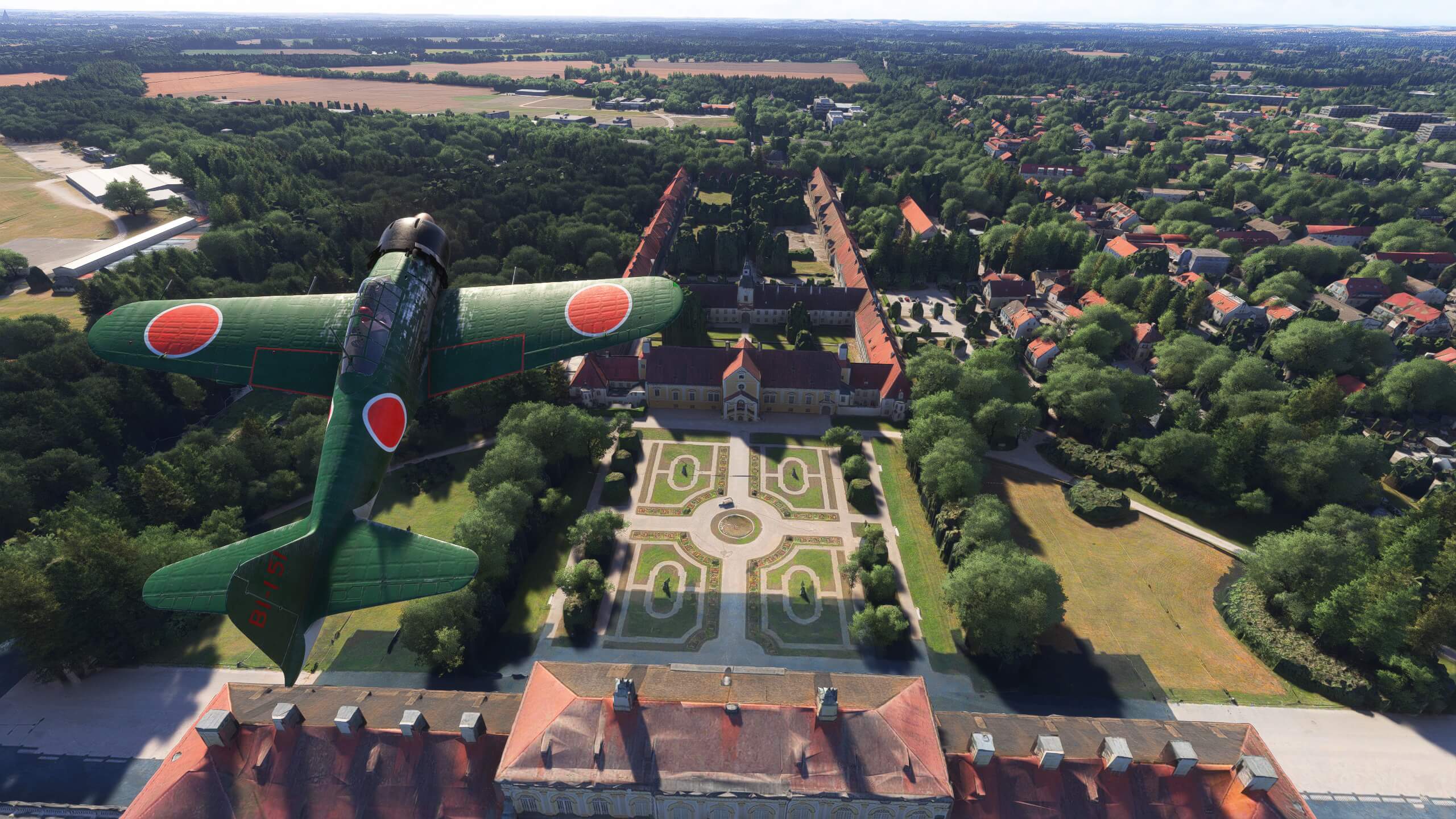 A green propeller aircraft flies over a mansion