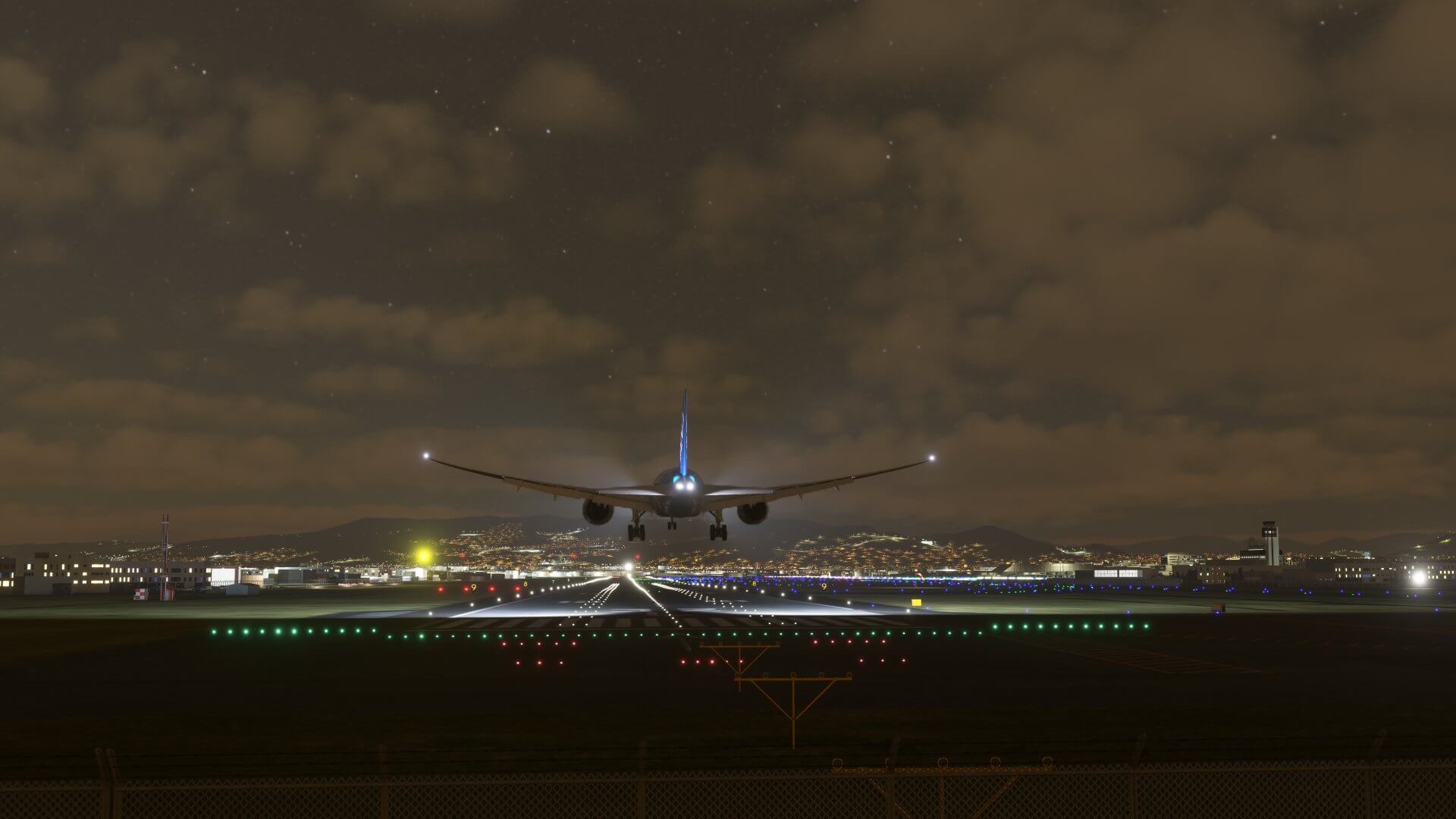 A Boeing 777 flares for landing at a major international airport at night