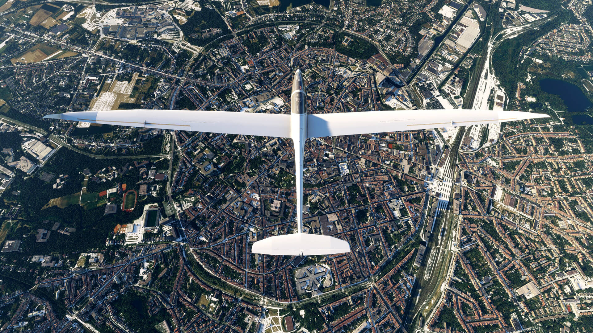 A white glider cruises high over a busy city