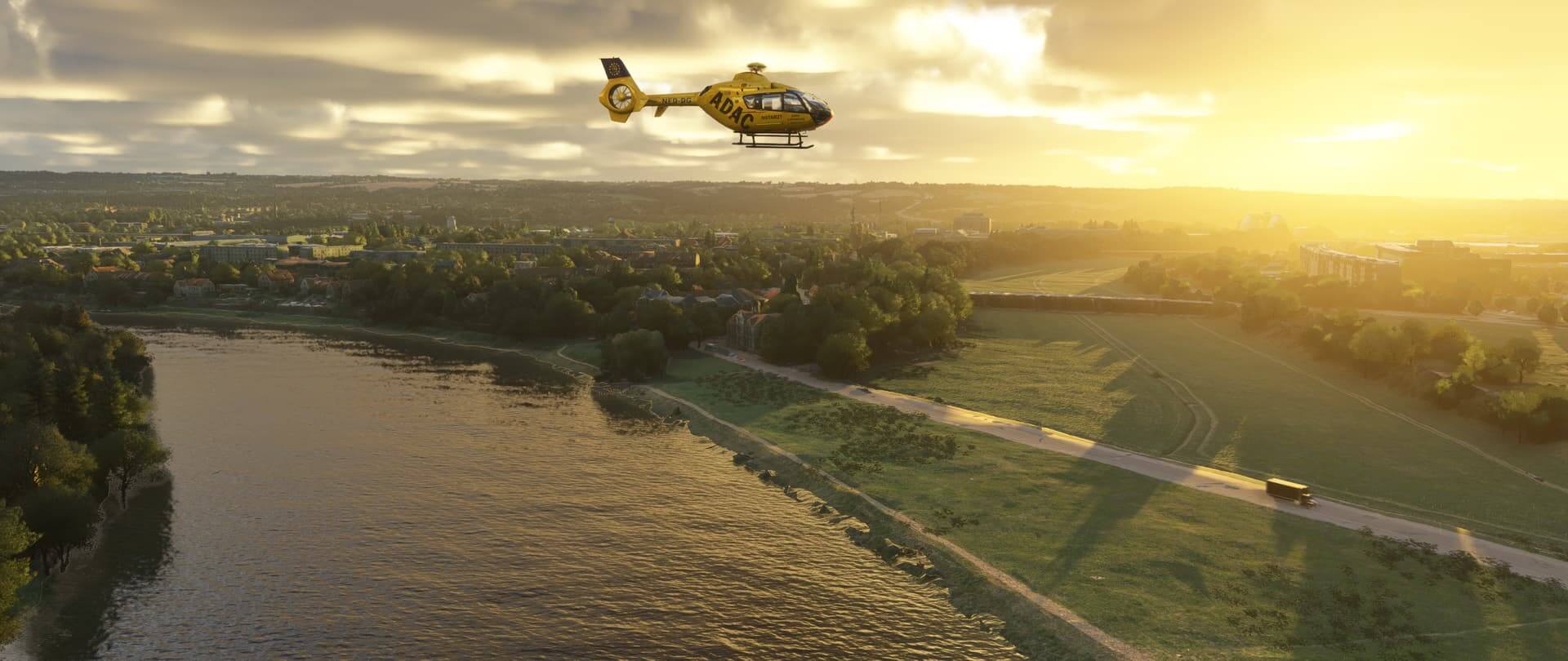 An ADAC EC-135 helicopter cruising during golden hour
