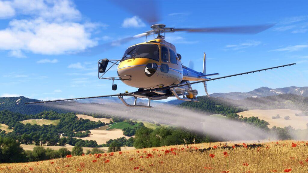A helictopter taking off from a golden field