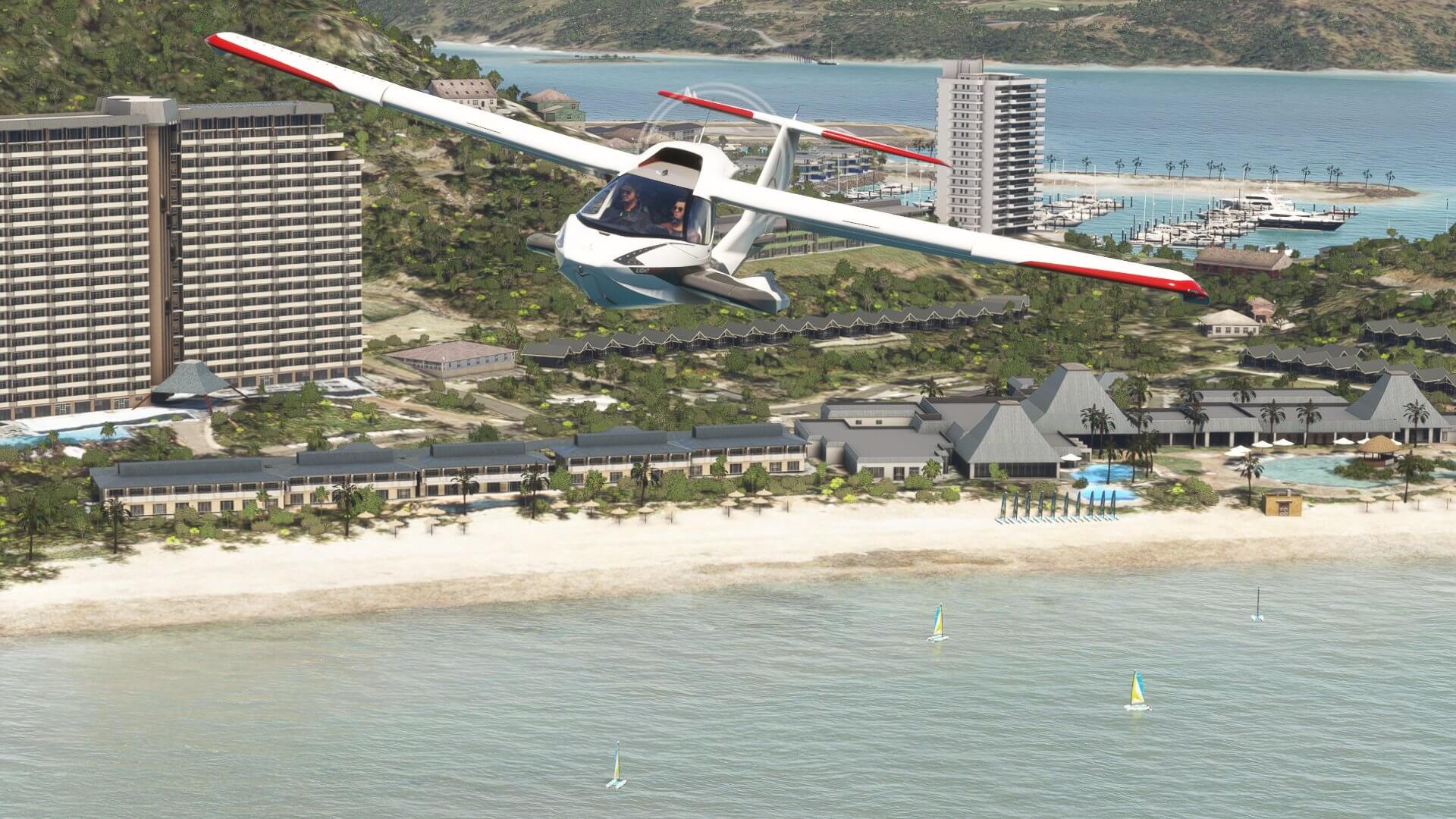 The Icon A5 flies past a beach resort