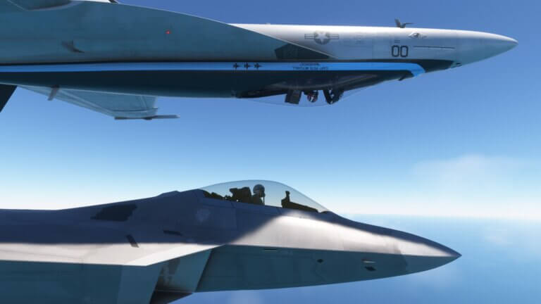 An F/A-18 Hornet in an inverted roll directly above an F-22 fighter jet