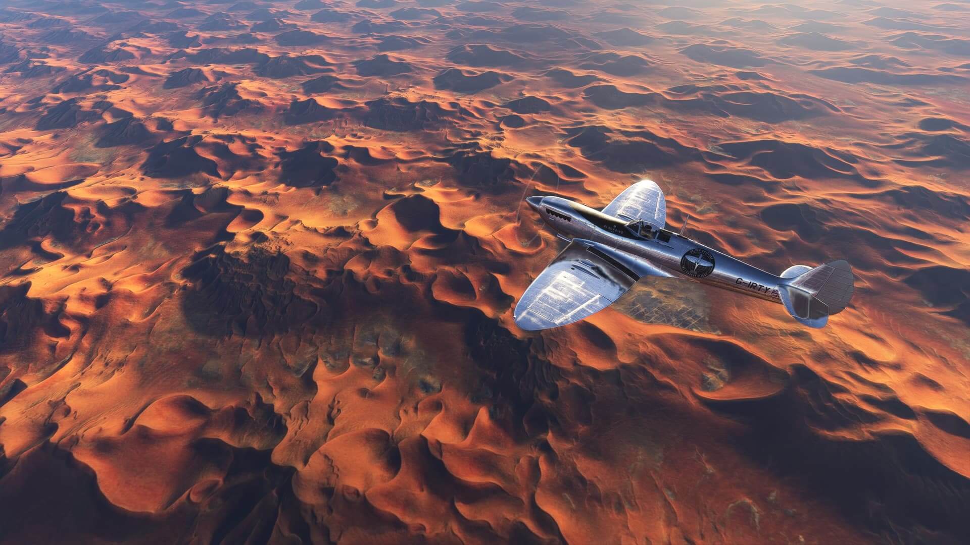 A bright silver vintage fighter aircraft cruises high over a desert