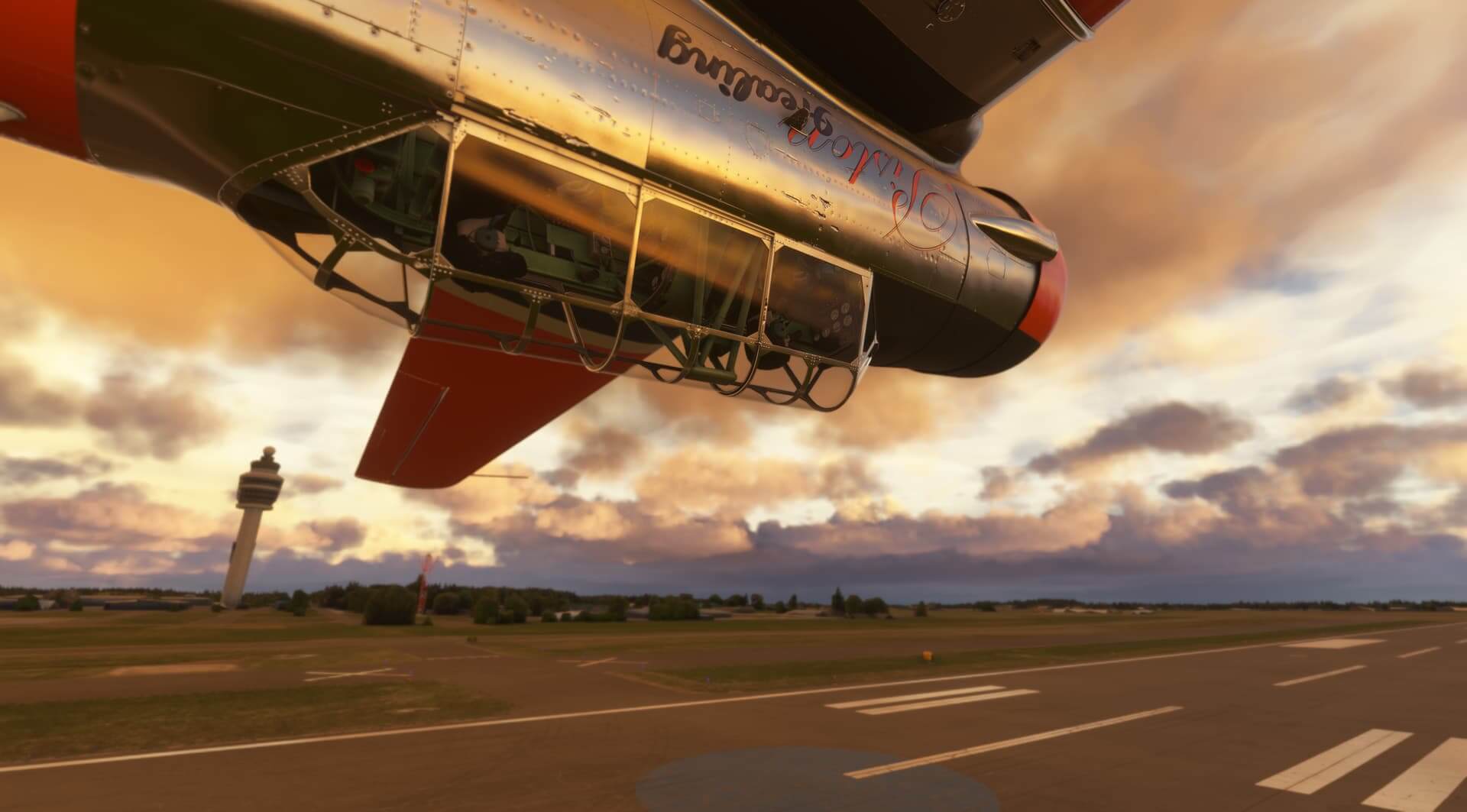 A T-6 Texan performing an inverted pass down a runway