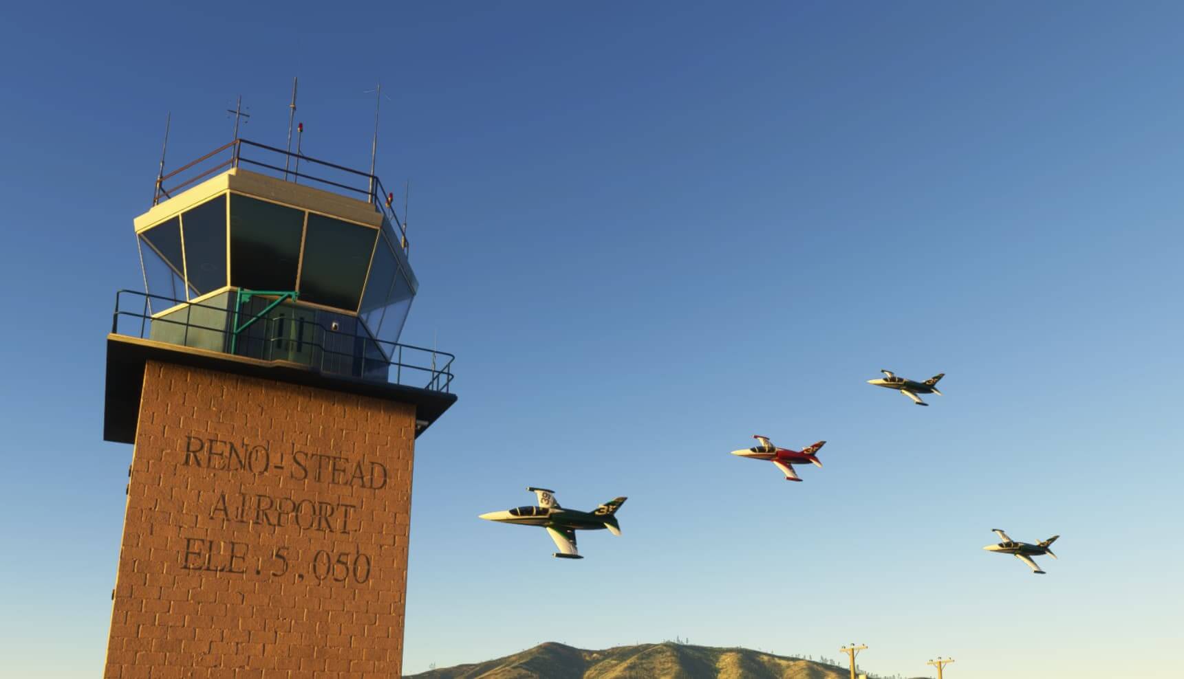 Four fast jet racers pass the Reno-Stead Airport ATC tower