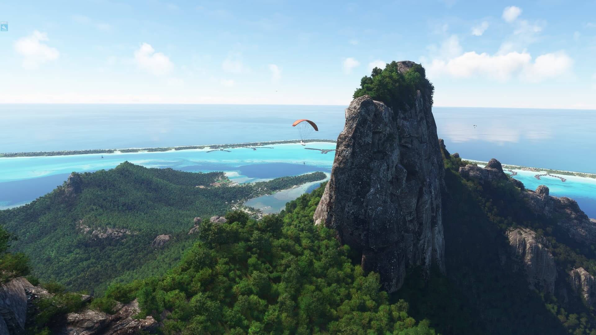A gyrocopter flies close to high rising terrain on an island