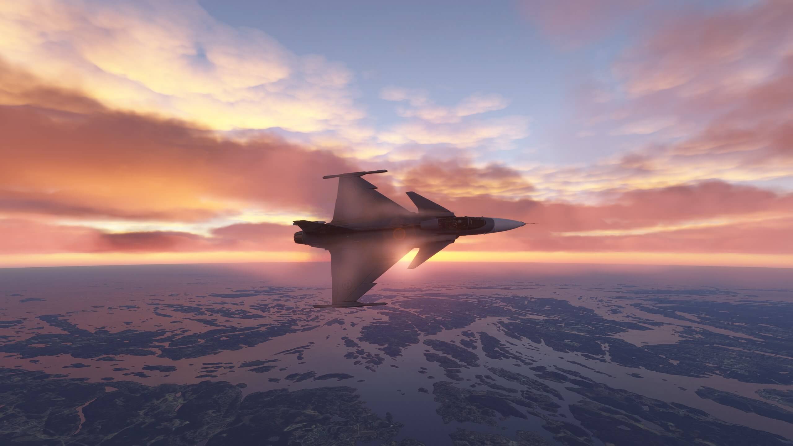A military fighter jet banks sharply to the right during sunset