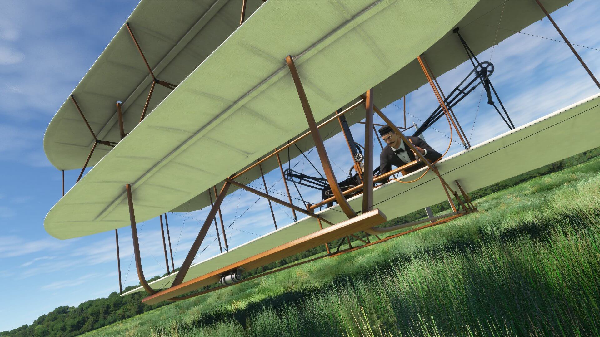 The Wright Brothers aircraft flying low over a grass field