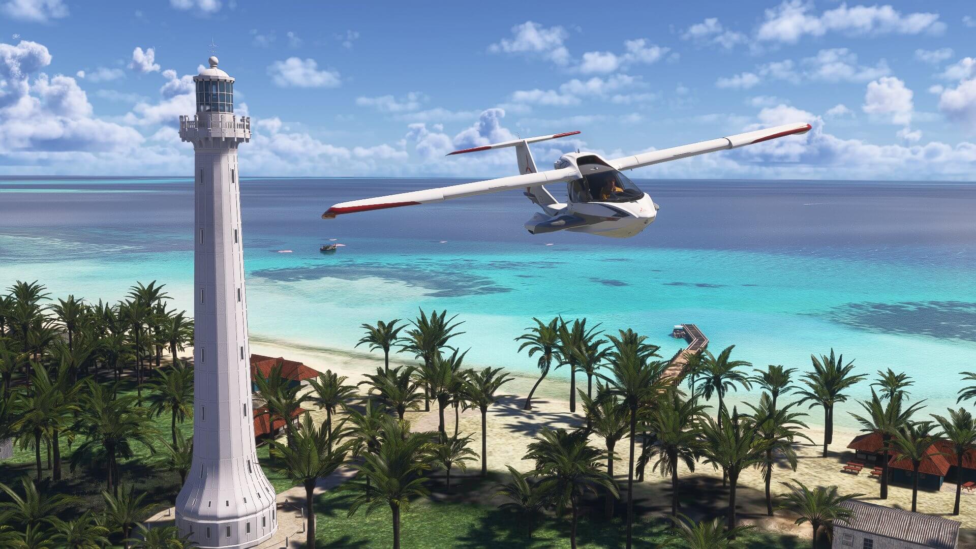 An Icon A5 flies over a beach with a lighthouse next to the aircraft